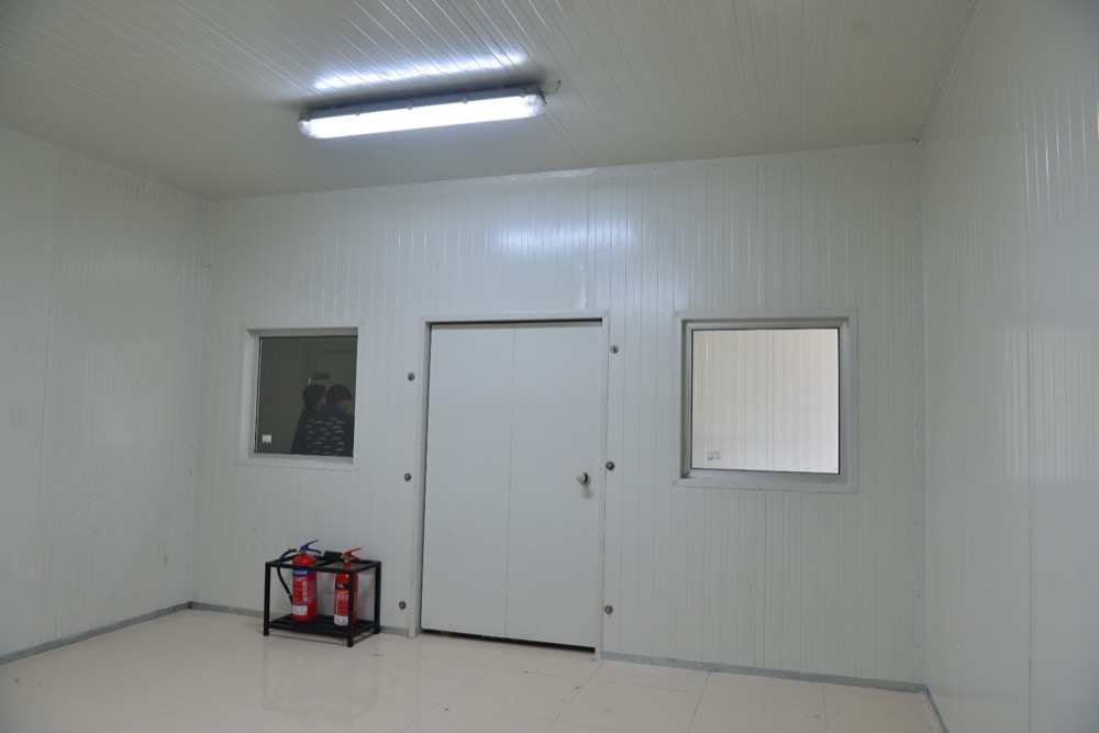 Climate test chamber interior at Haier Lahore — PIR-clad walls, ceiling, and inspection door, white-painted finish, controlled environmental testing room