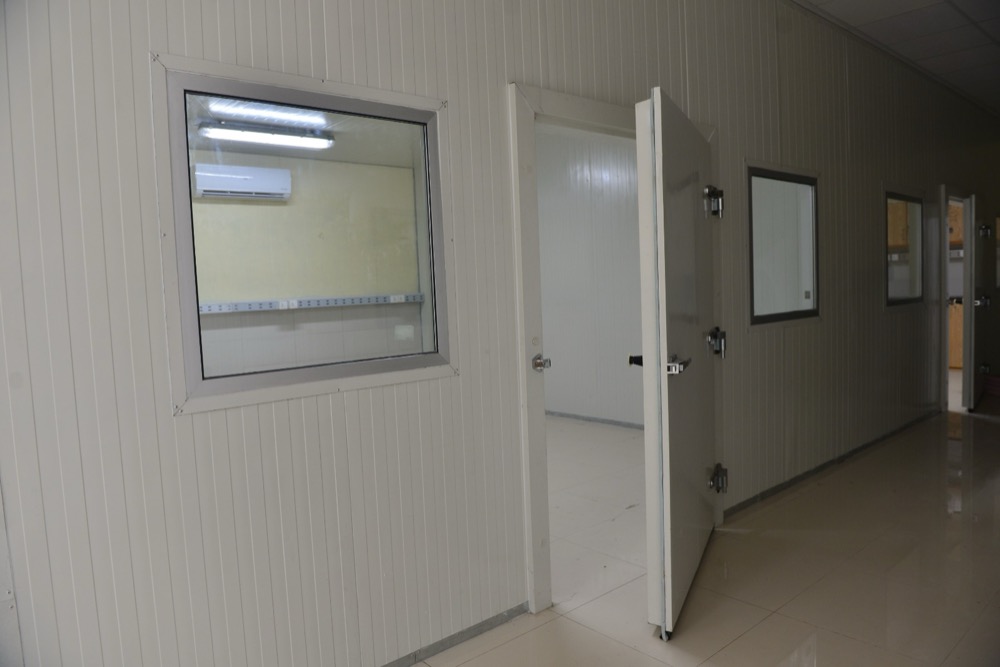 Climate test chamber detail at Haier Lahore — PIR sandwich panel wall finish, sealed coves, instrumentation pass-through